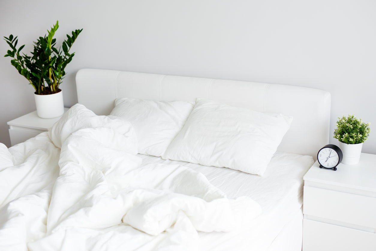 white bamboo quilt on a messy bed