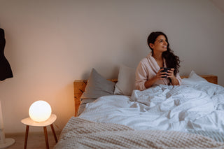 Woman in bed with bamboo mattress topper