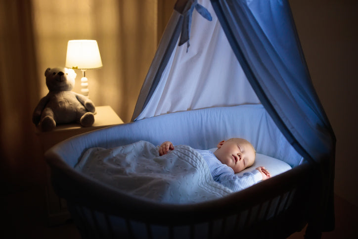 Baby sleeping on mattress protector in crib 