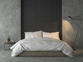 Bed with mattress protector in bedroom