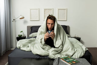 Man wrapped up in bamboo sheets