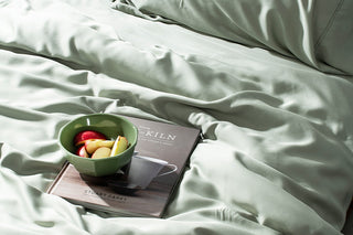 sage quilt cover with book resting on top