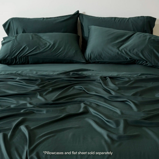 Cooling Bamboo Fitted Sheet in Midnight Pine, on a made bed