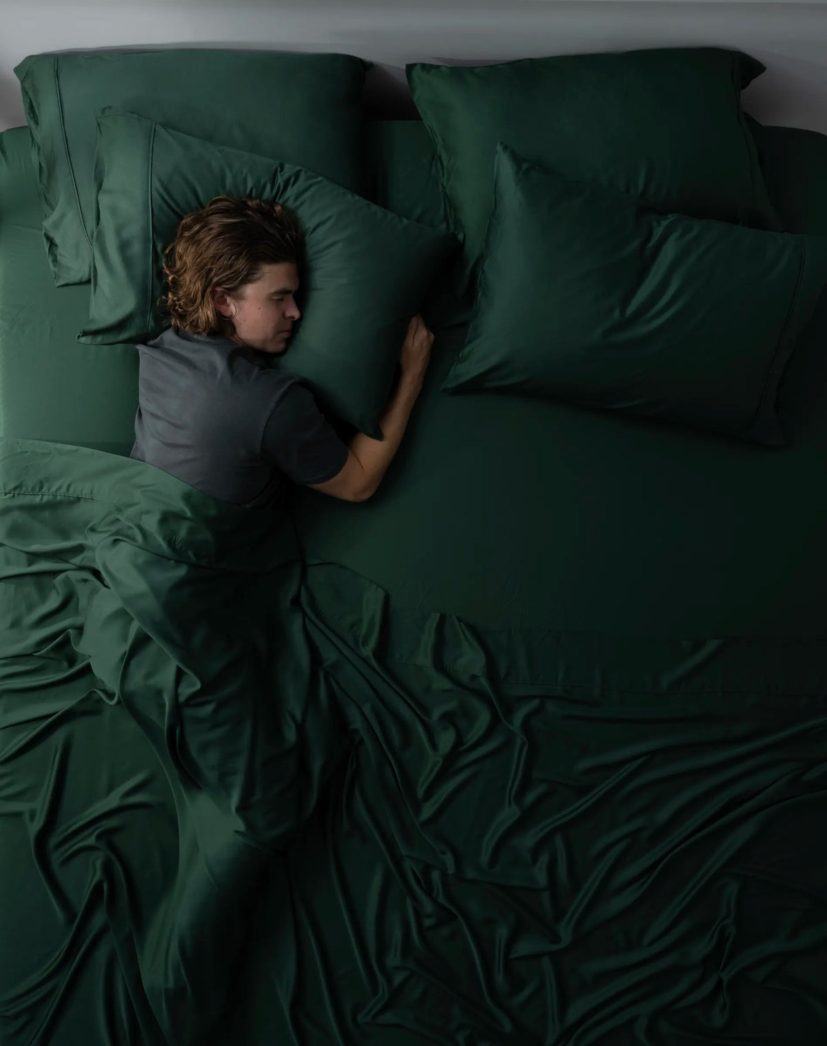 Person asleep in Ecoy Cooling Bamboo sheets in Forest Green