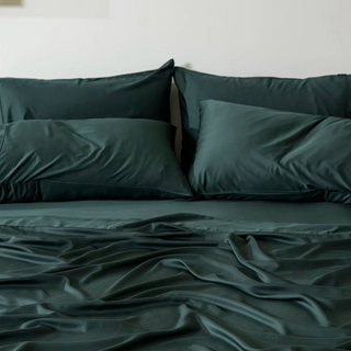 Fur-friendly Bamboo Pillowcase Set in Midnight Pine, on a made bed