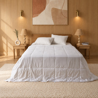 Lightweight summer quilt on a bed