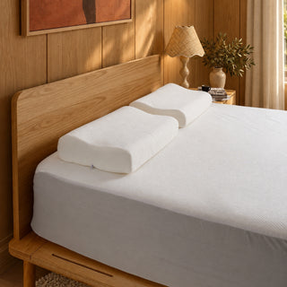 Ergonomic memory foam pillows on a bed