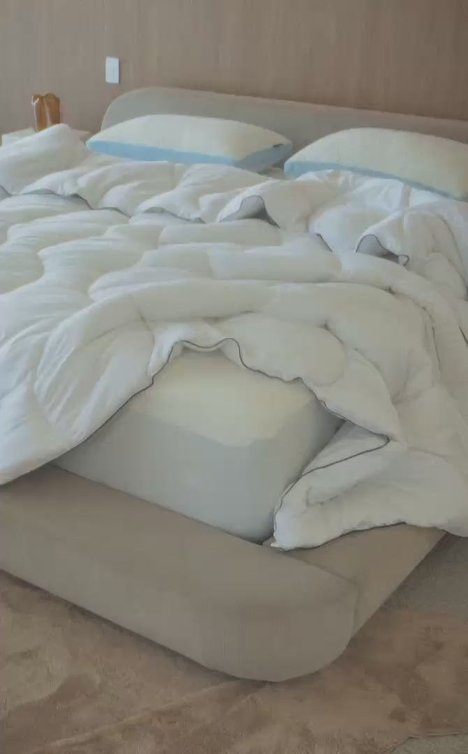 Cloud Quilt and cooling pillows on a made bed